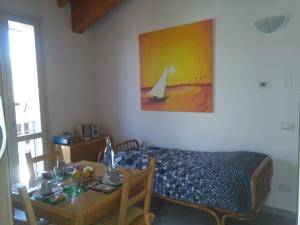 a bedroom with a bed and a table with a sailboat on the wall at Up b&b in Offanengo