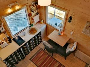 an overhead view of a kitchen and dining room in a tiny house at Self Check-in Sauna Cabin next to Hiking Trails in Kärde