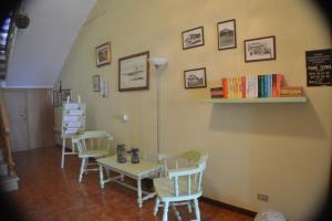 a dining room with chairs and a table and books at Hotel Il Poggetto in Castellina Marittima