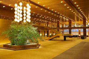 a large room with a large clock on the ceiling at The Okura Tokyo in Tokyo