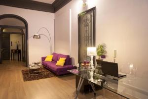 a living room with a purple couch and a glass table at Umma Barcelona B&B Boutique in Barcelona