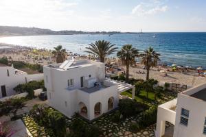 an aerial view of the beach and buildings at Villa Acquamarina sul mare in San Vito lo Capo