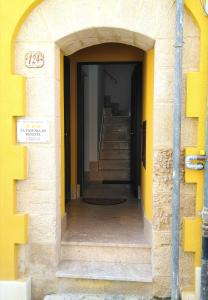 an entrance to a building with yellow walls and stairs at La Dimora Di Segesta B&B in Calatafimi