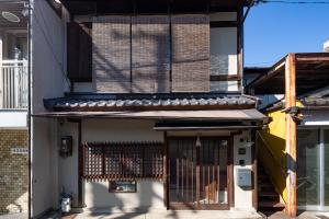 an entrance to a building with a gate at JISHO-AN in Kyoto