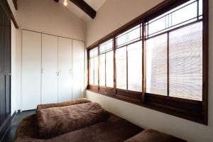 a room with a couch and a large window at JISHO-AN in Kyoto