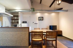 a kitchen with a table and chairs in a room at JISHO-AN in Kyoto