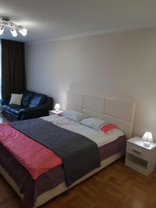 a bedroom with a large bed and a couch at Apartment in Ternopilʼ