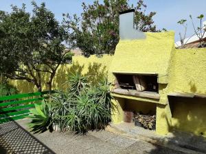 a yellow building with a hole in the side of it at Artistika Golden Apartment in Capitana