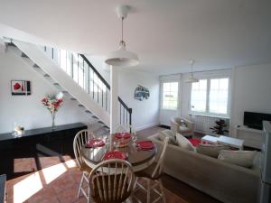 a living room with a table and a couch at Les Gîtes du Couesnon in Pontorson