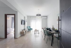 a dining room and living room with a table and chairs at Casa Ntore Luxury Apartments in Chania Town