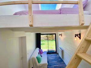 a room with two bunk beds in a house at La Brie à 15mn de Disneyland et Village Nature in Neufmoutiers-en-Brie