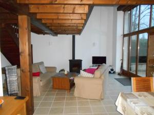 a living room with two couches and a fireplace at Coutancie in Nanteuil-de-Bourzac