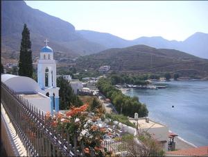 a view of a town with a church and a river at Themelina Studios in Emborios Kalymnos
