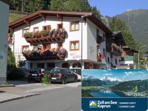 a building with flowers on the balconies on a street at Zimmervermietung Babsy in Zell am See