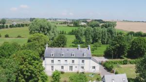 an aerial view of a white house in a field at Les Gîtes du Couesnon in Pontorson