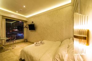 a hotel room with a bed and a window at AC Residence - Behind Cititel Hotel in Kota Kinabalu