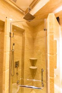 a shower with a glass door in a bathroom at AC Residence - Behind Cititel Hotel in Kota Kinabalu