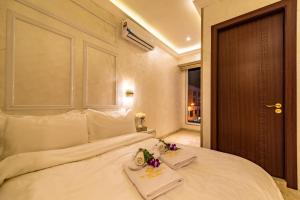a bedroom with a white bed with two towels on it at AC Residence - Behind Cititel Hotel in Kota Kinabalu