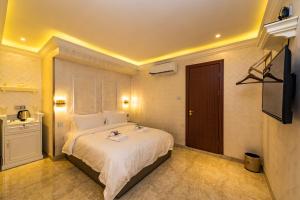 a bedroom with a large bed and a television at AC Residence - Behind Cititel Hotel in Kota Kinabalu