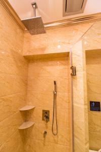 a bathroom with a shower with a glass door at AC Residence - Behind Cititel Hotel in Kota Kinabalu
