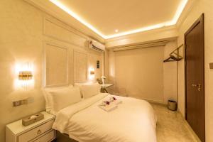 a bedroom with a white bed with a tray on it at AC Residence - Behind Cititel Hotel in Kota Kinabalu