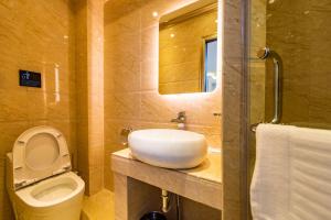 a bathroom with a sink and a toilet and a mirror at AC Residence - Behind Cititel Hotel in Kota Kinabalu