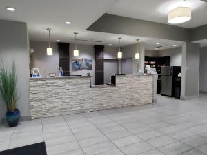 a lobby with a stone counter in a building at Hawthorn Suites by Wyndham San Angelo in San Angelo