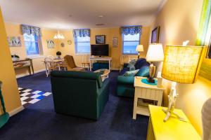 a living room with a couch and a dining room at The Flanders Hotel in Ocean City