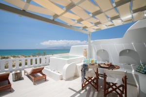 a balcony with a view of the ocean at Nikos & Maria Apts - Suites in Plaka