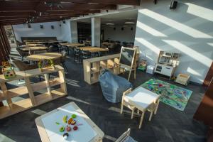 an overhead view of a restaurant with tables and chairs at Baltas gandras in Naisiai