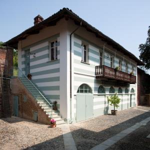 a white and blue house with a balcony at Tenuta Tamburnin in Castelnuovo Don Bosco