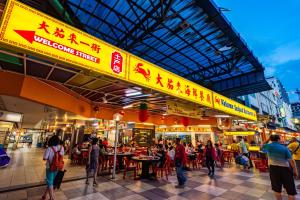 a group of people walking around a food market at AC Residence - Behind Cititel Hotel in Kota Kinabalu