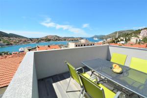 a balcony with a table and chairs on a roof at Villa Rosa in Dubrovnik