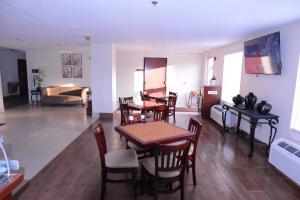 a dining room and living room with a table and chairs at Jameson Inn and Suites Hazelhurst in Hazlehurst