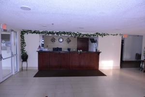 a lobby with a reception desk and plants on the wall at Jameson Inn and Suites Hazelhurst in Hazlehurst