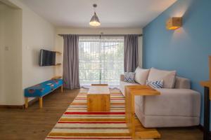 a living room with a couch and a table at Sports Road Apartments by Dunhill Serviced Apartments in Nairobi