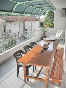 a wooden table and chairs on a balcony at Apartments Mare in Makarska