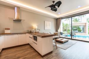 a kitchen and living room with a view of a pool at Zee Luxury Boutique Hotel in Hinkong