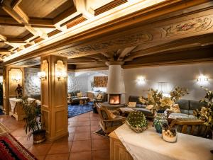 a large living room with a fireplace in a building at Hotel Roy in Malga Ciapela