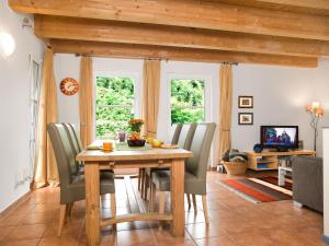 a dining room with a wooden table and chairs at Haus Meerforelle Haus Meerforelle Wohnung 1 in Insel Poel