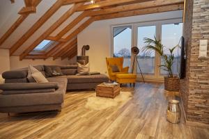 a living room with a couch and a chair at Penthaus Regine in Bruchhausen