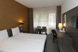 Postel nebo postele na pokoji v ubytování Golden Tulip Ampt van Nijkerk
