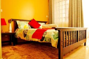 a bedroom with a bed with a crib and a window at Sherry Homes - Raha in Nairobi