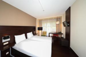 Postel nebo postele na pokoji v ubytování Golden Tulip Ampt van Nijkerk
