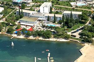 an aerial view of a lake with a boat in the water at Hotel Zorna Plava Laguna in Poreč