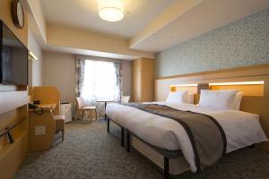 Postel nebo postele na pokoji v ubytování Hotel Monterey Kobe