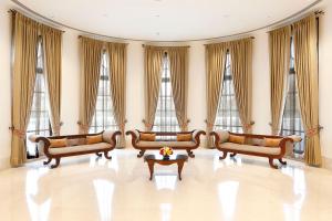 a living room filled with furniture and a large window at Taj Mahal Lucknow in Lucknow