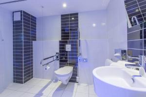 a bathroom with a toilet and a sink at Holiday Inn Express Neunkirchen, an IHG Hotel in Neunkirchen