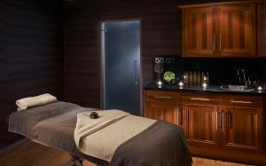 a kitchen with a bed and a refrigerator at Slaley Hall Hotel, Spa & Golf Resort in Slaley