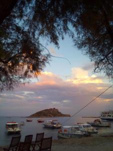 a group of boats in the water at sunset at La Casa Di Nonna in Koríthion